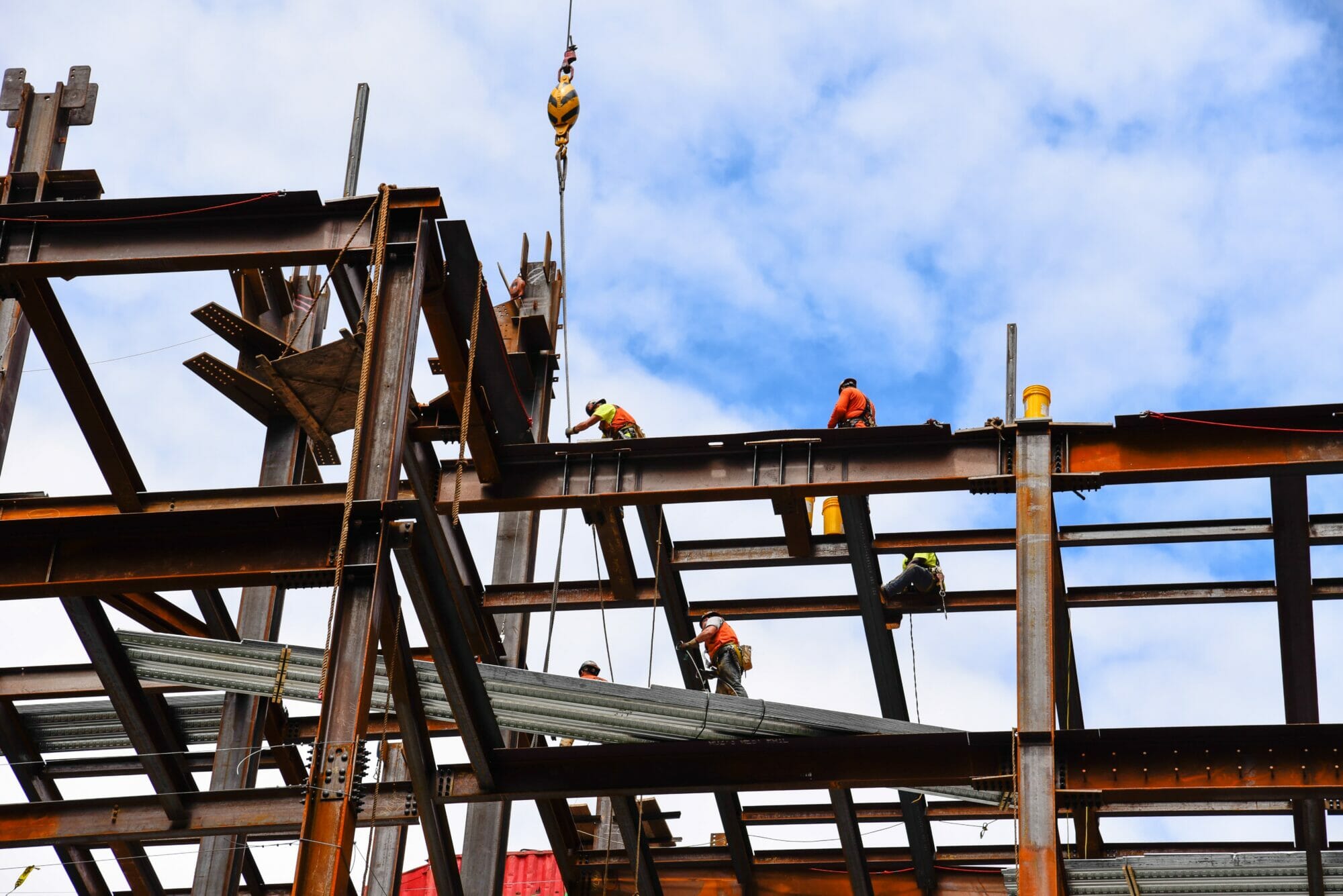 Construction workers on steel beams in construction site